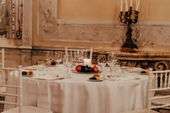 Luxury Candlelit Wine Dinner Sophisticated formal dining table set with fine wine glasses and romantic candle lighting.