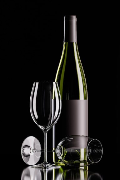 Chilled White Wine Pour Chilled white wine being poured into a sleek crystal glass next to a wine bottle.